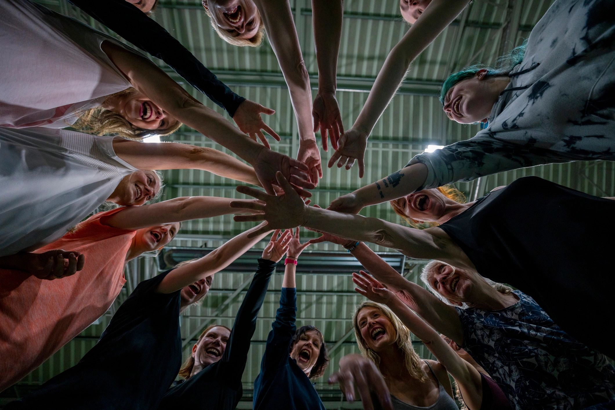 Team members joining hands in support