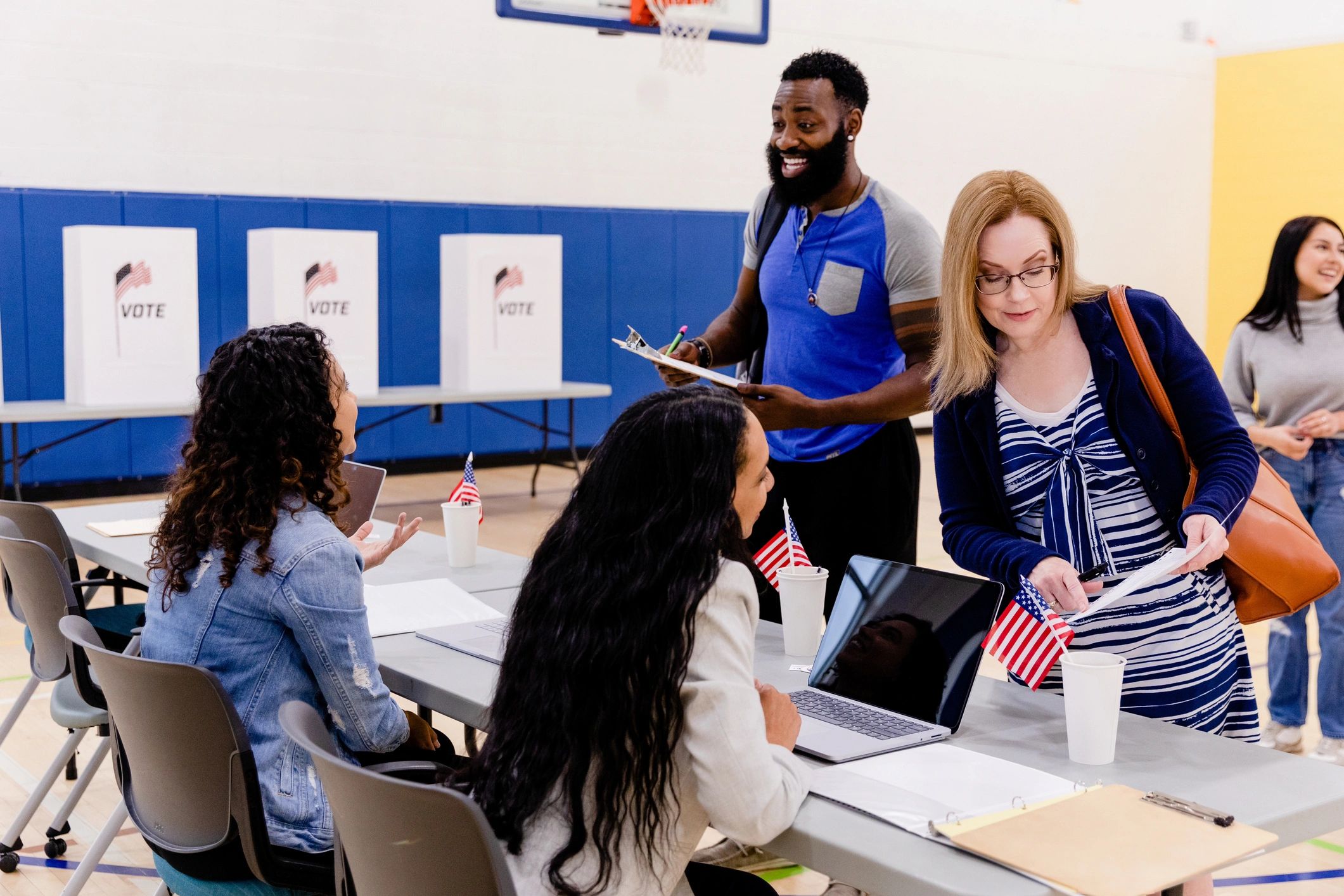 Election volunteers welcoming voters at a community center